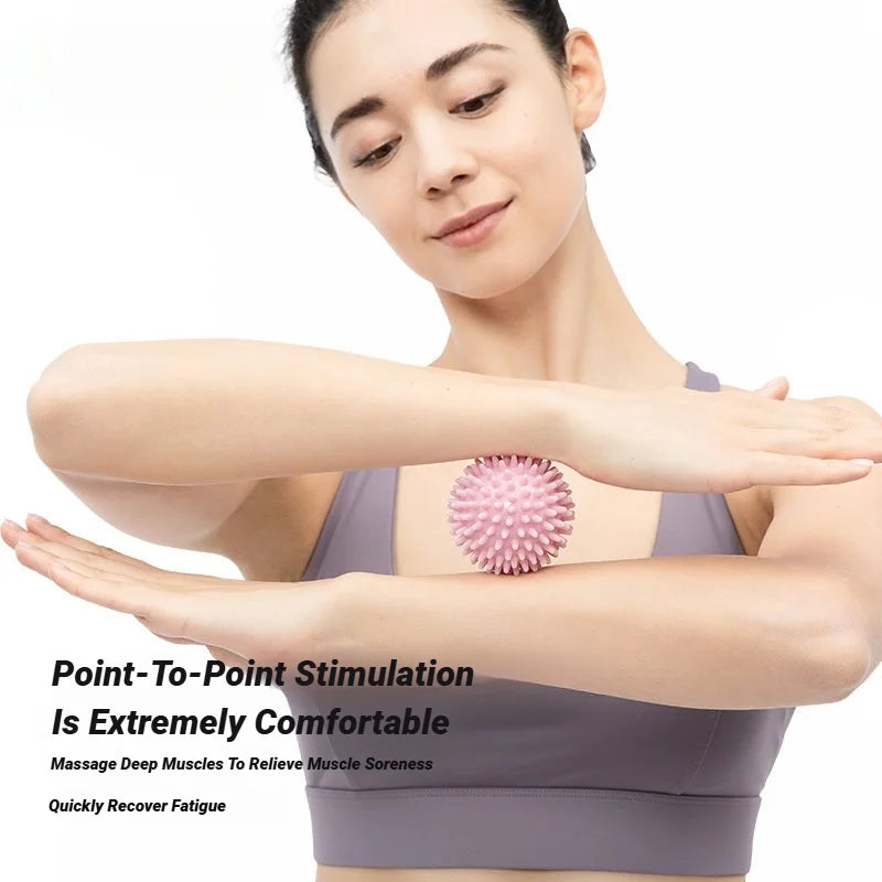 Pink spiky massage ball on forearm while holding position for muscle relief
