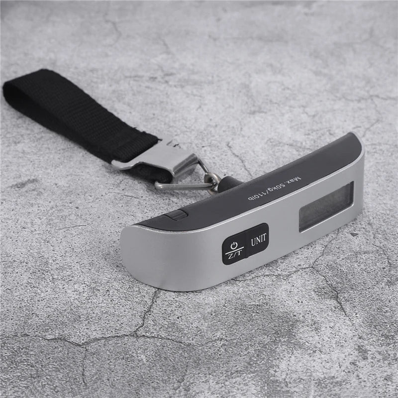 Portable digital luggage scale with black strap and metal hook on base