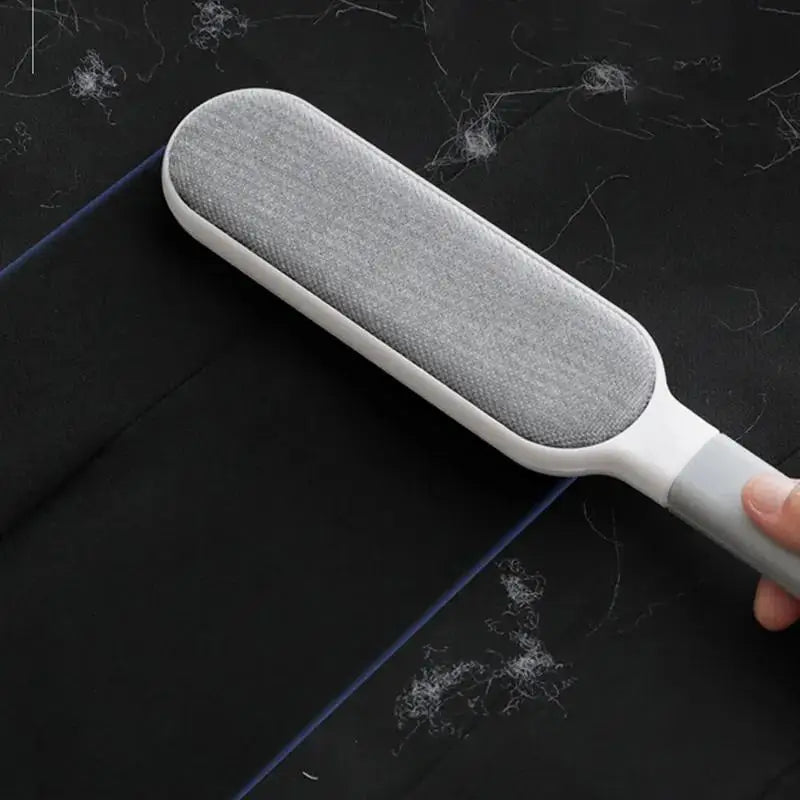 Gray and white manual pet hair remover lint brush with textured oval pad