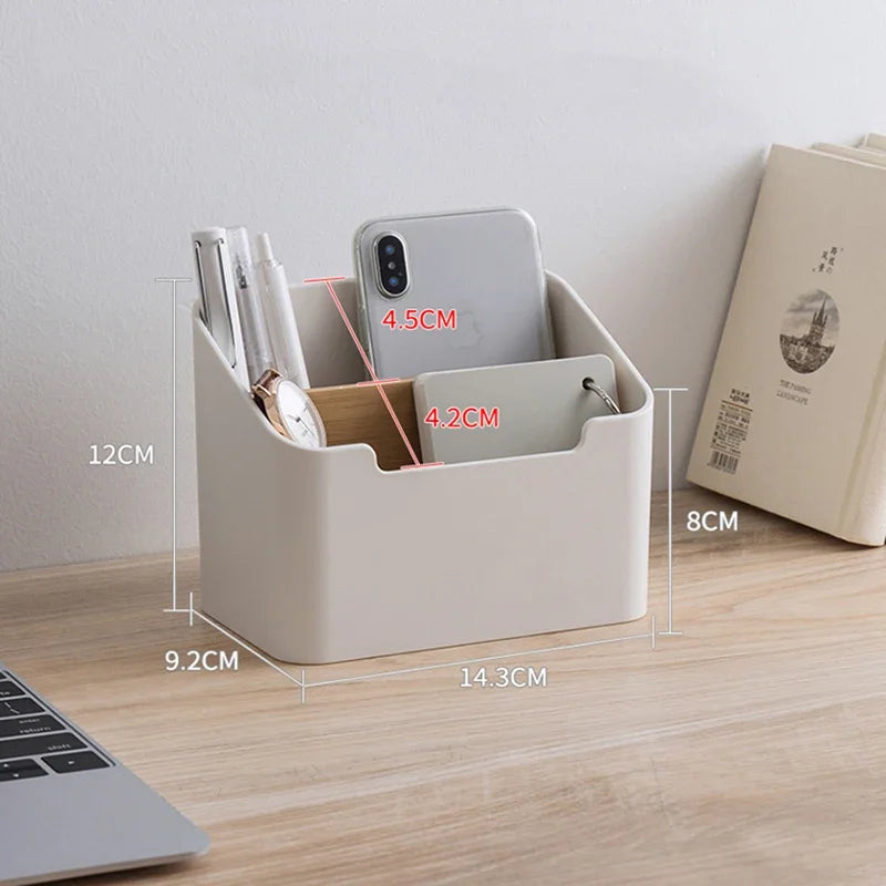 White plastic desktop storage box with two sections and open top for remotes