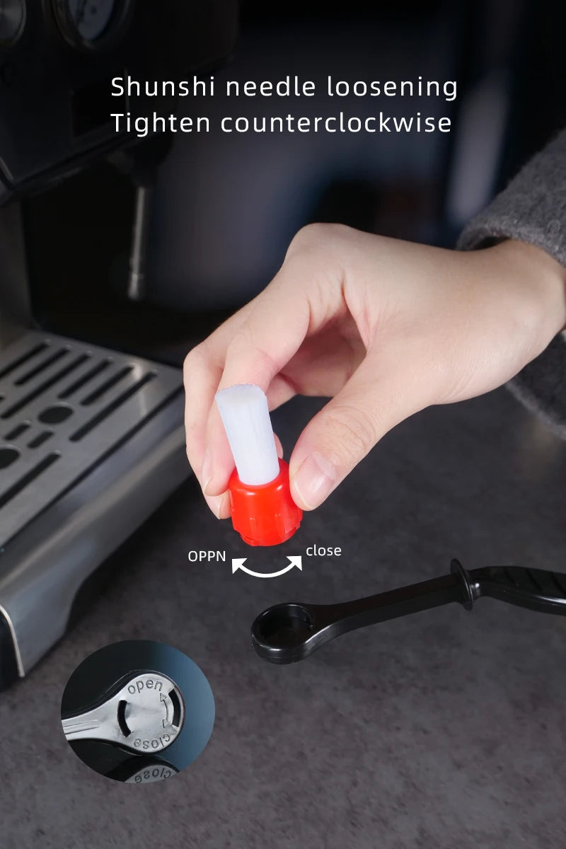 Hand holding coffee cleaning brush head, red base with white bristles