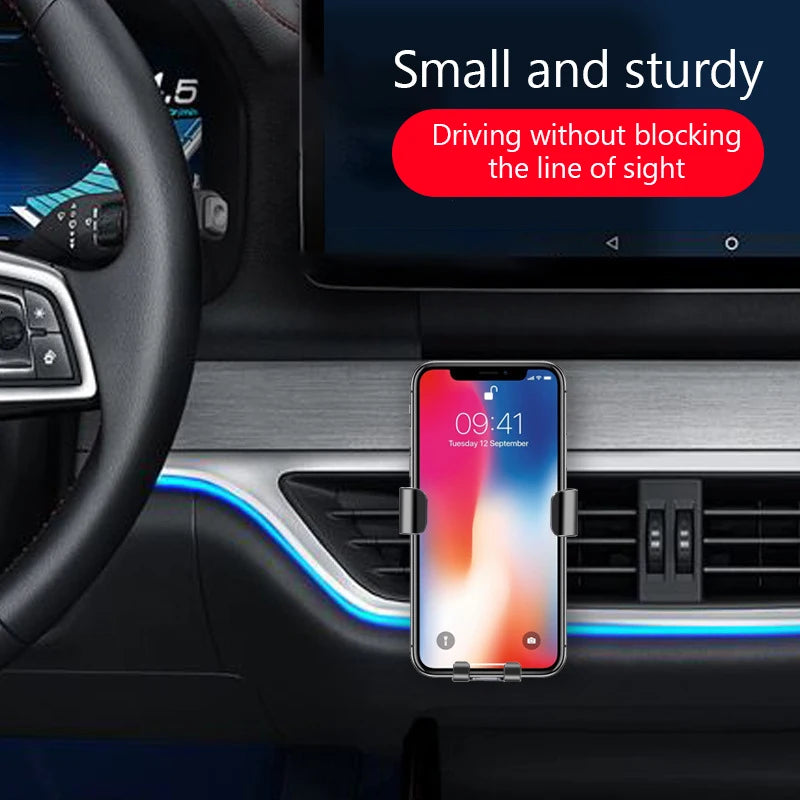 Black dashboard car phone holder with two side grips, holding a smartphone in view