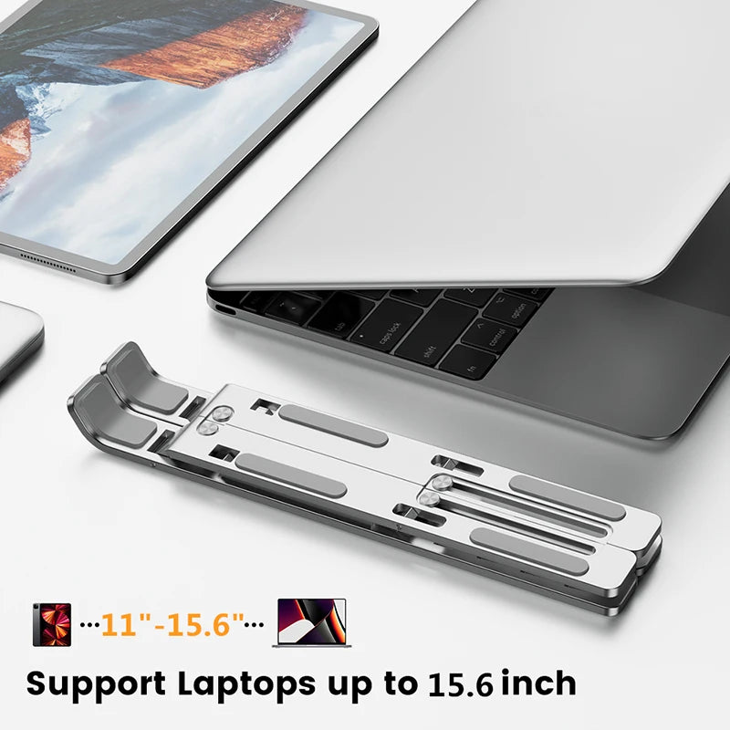 Silver foldable laptop stand under notebook, supports up to 15.6 in