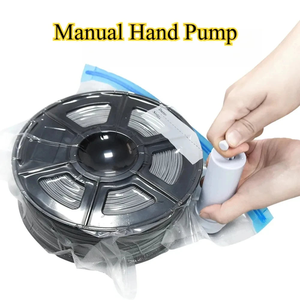 Hand-operated pump sealing a blue filament vacuum bag around a spool