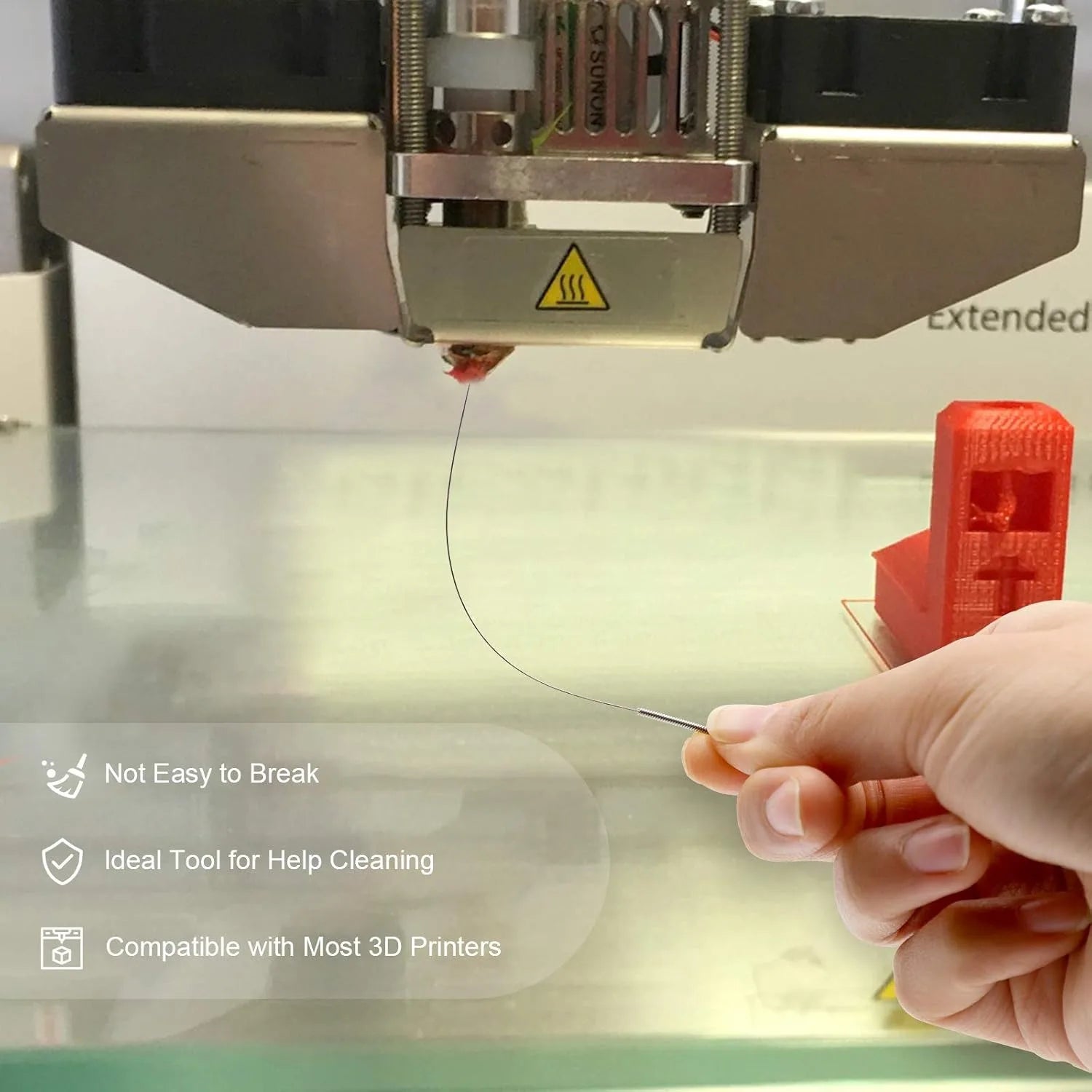 Metal cleaning tool held near a 3D printer nozzle