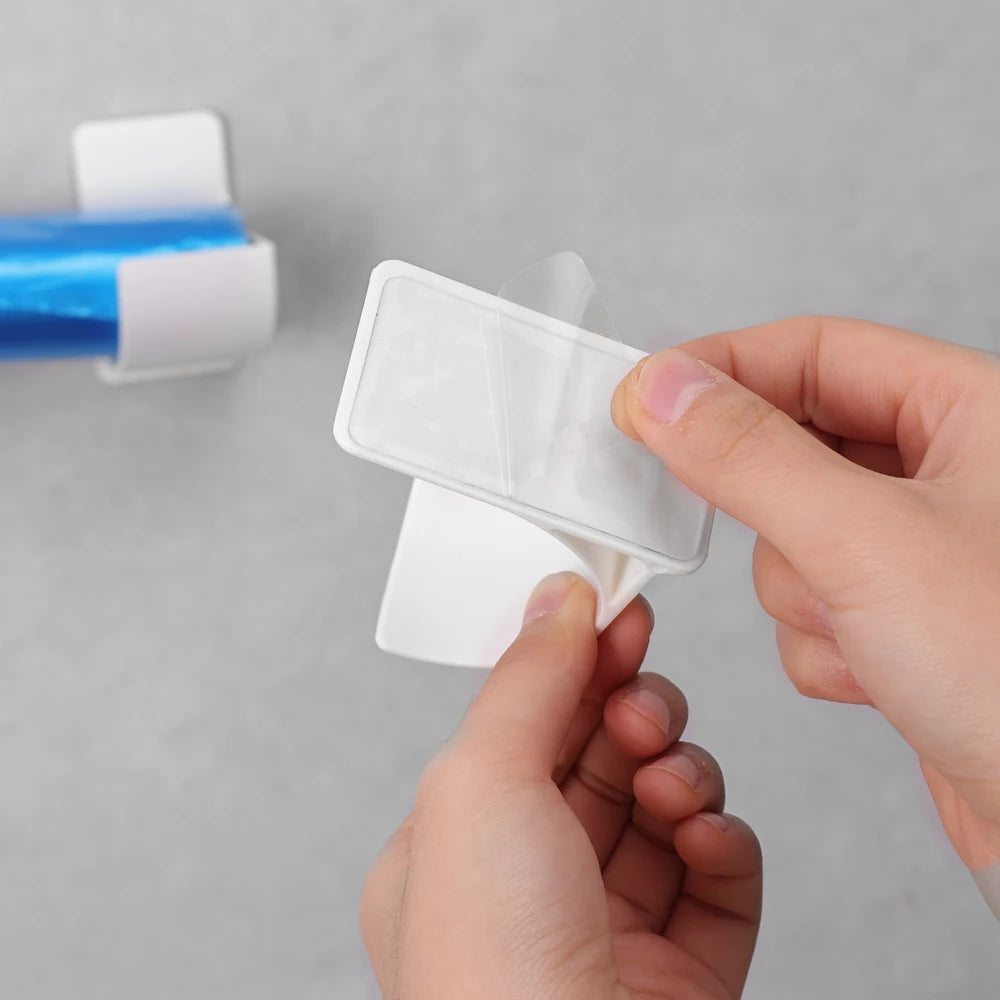Plastic wall trash bag holder with clear flap cover and white clips