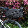 Black hard-shell bicycle rear bag mounted on rack with bottle pouch and rear reflector