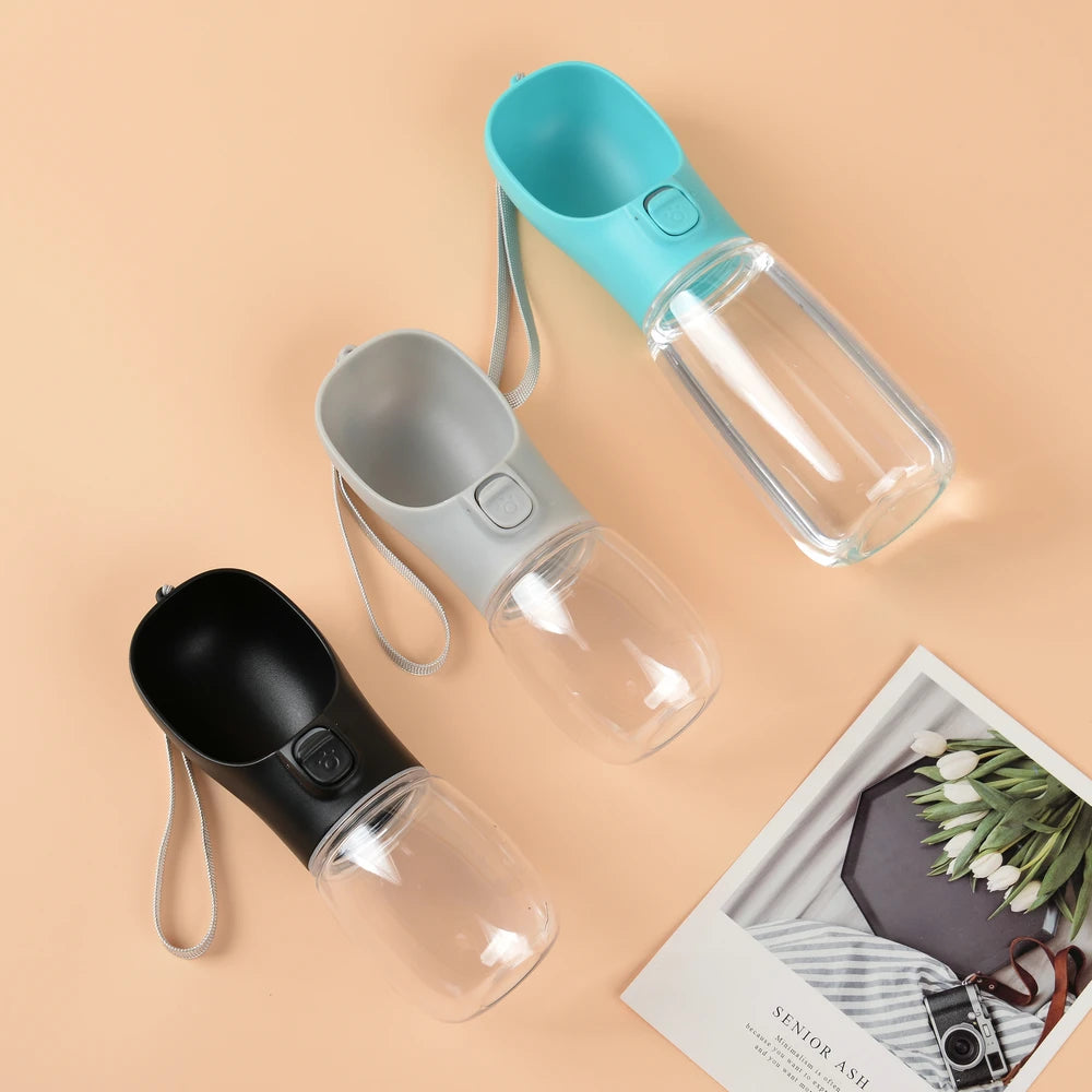 Portable pet water bottles with carry straps, showing teal, gray, and black spouts