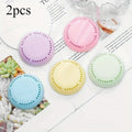 Five colorful round aromatherapy deodorizing tablets: purple, pink, yellow, blue, green