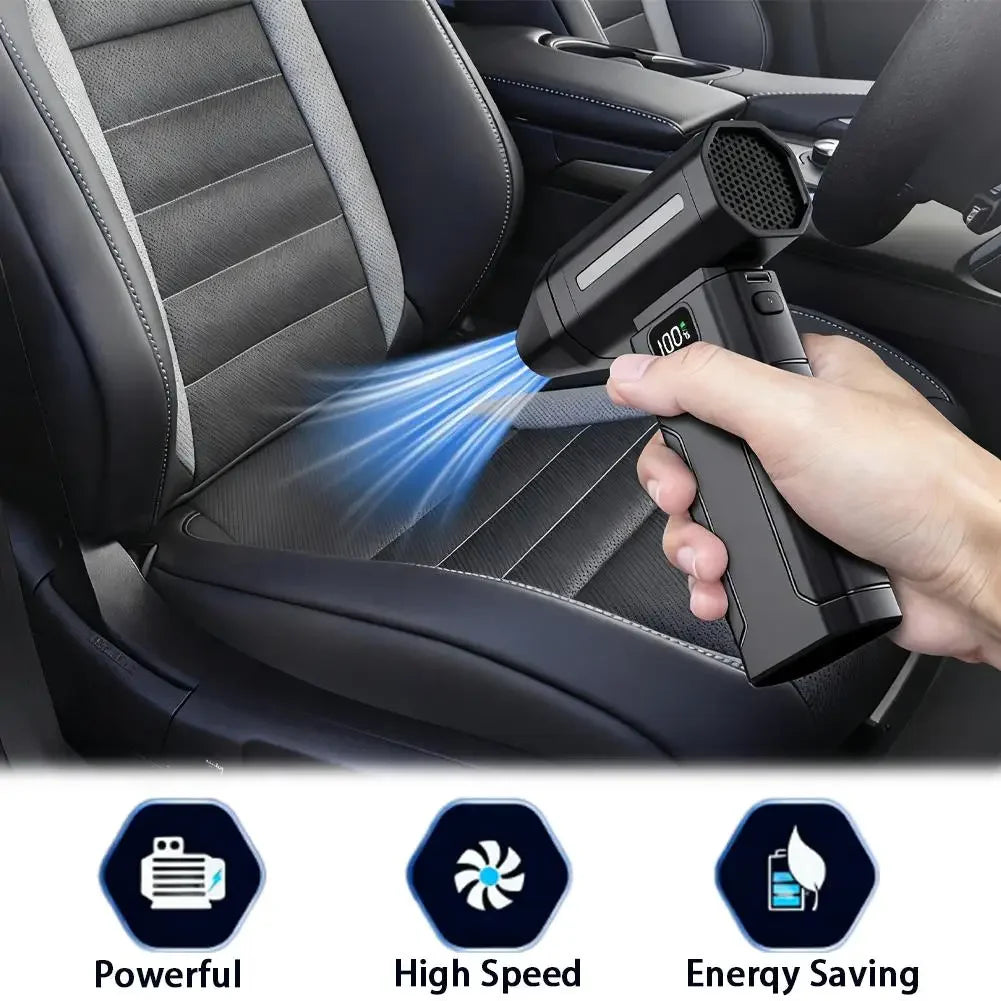 Black handheld fan blower in hand blasting air across car seat surface
