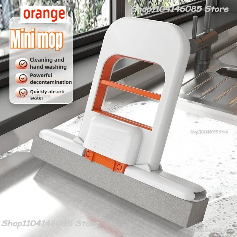 Orange mini handheld cleaning mop, white base with orange frame and sponge pad