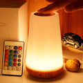 Portable touch night lamp with white diffuser and warm glowing light.