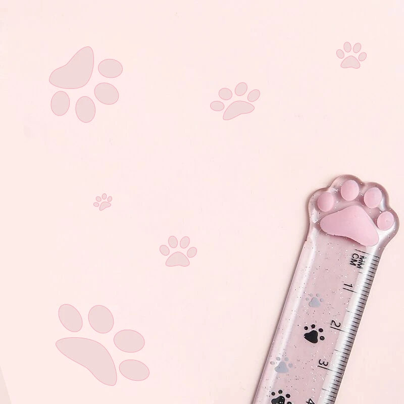 Pink cat paw plastic straight ruler corner view with paw print graphics on the scale