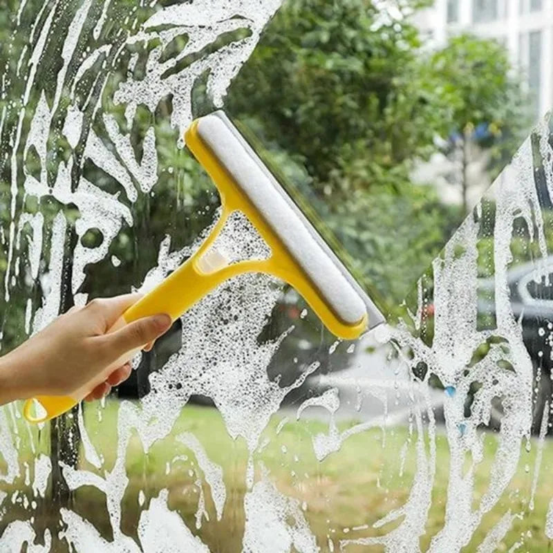 Yellow window squeegee wiper with rubber blade, lifting foam off glass