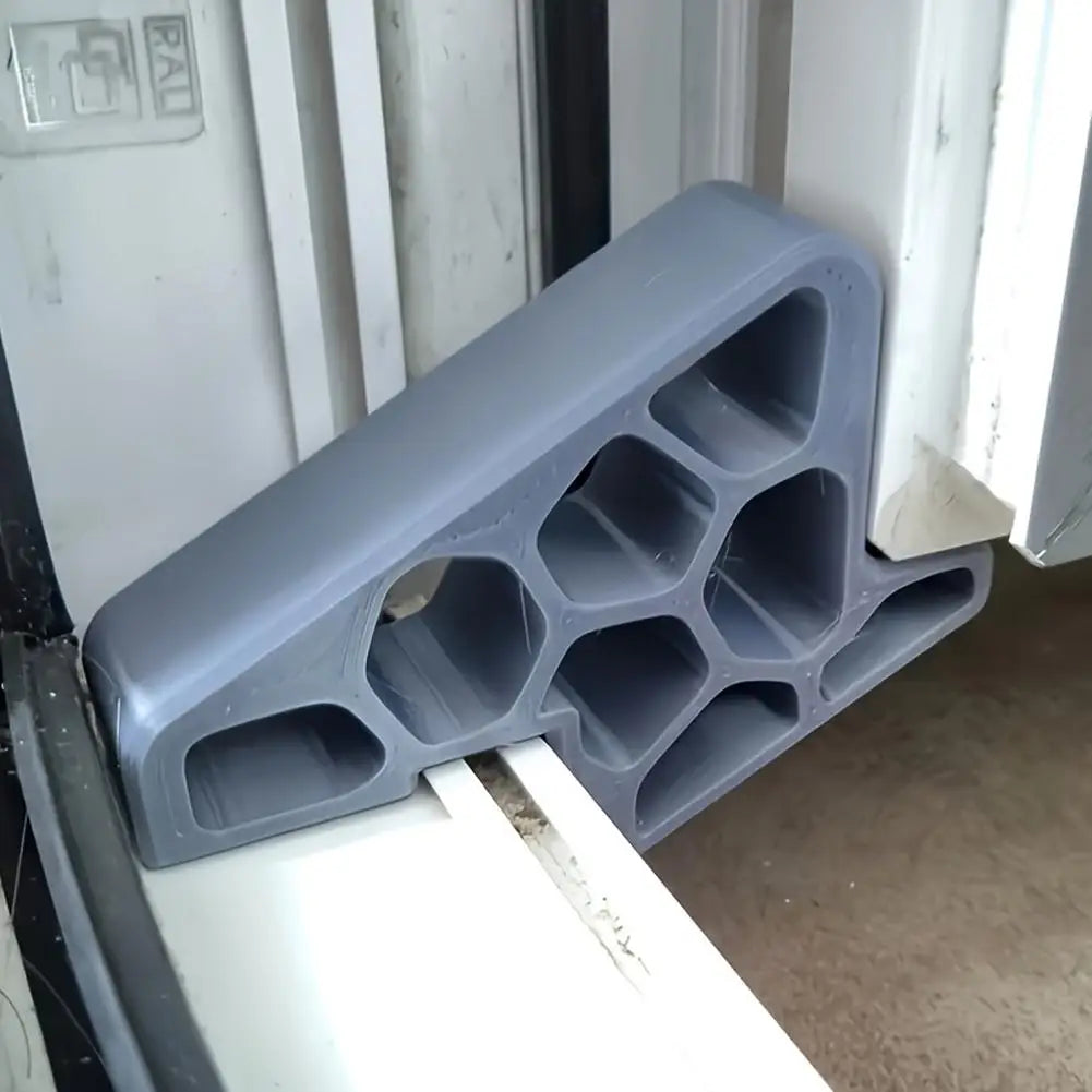 Gray window and balcony door stopper wedge installed along the sill