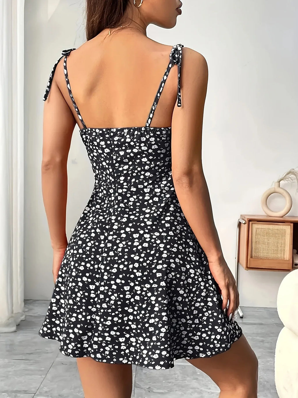 Black floral spaghetti strap short dress with open back and tie shoulder straps