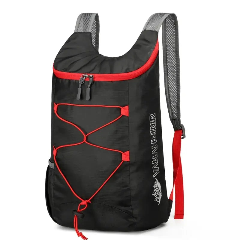 Black folding backpack with red trim, front pocket panels, and zipper closure
