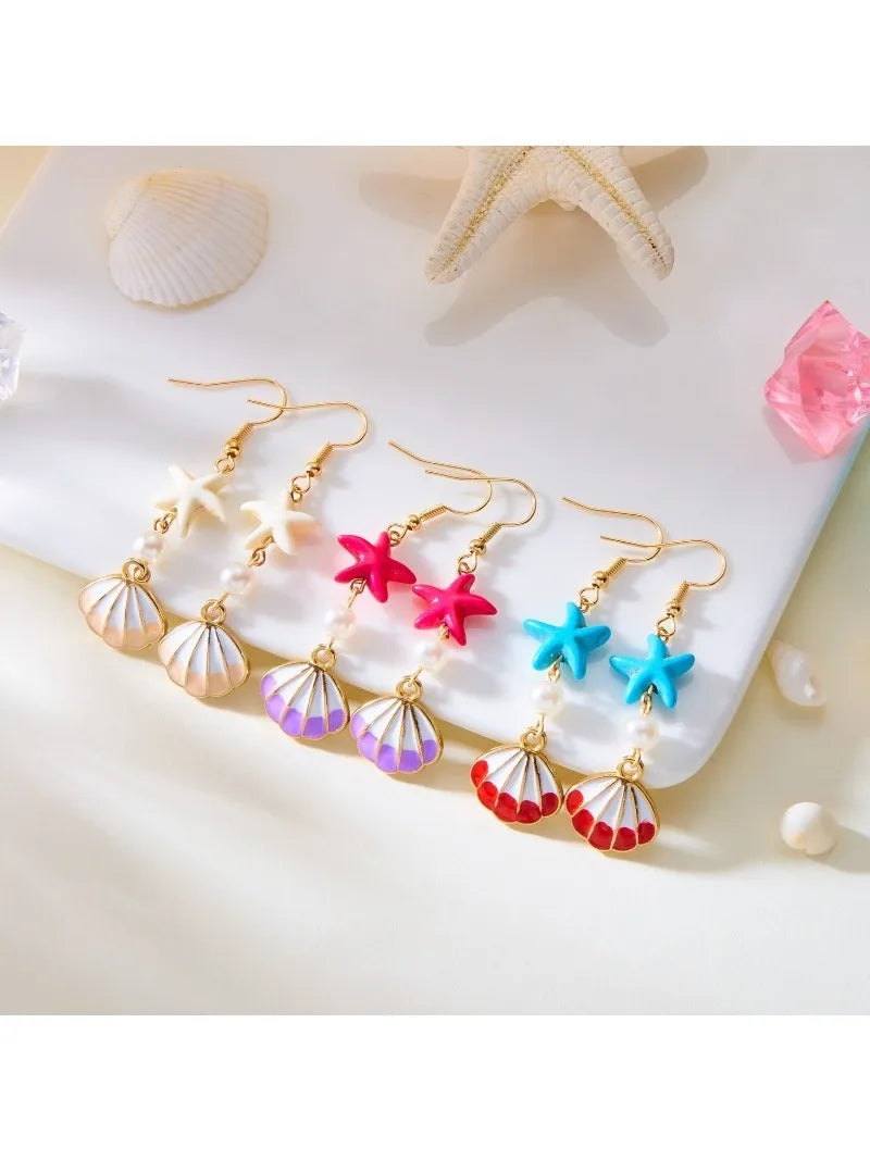 Assorted starfish and shell dangle earrings with pearl beads on gold hooks
