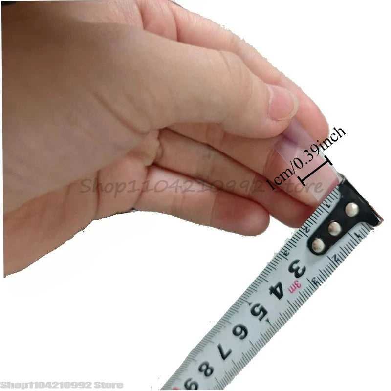 Double-sided adhesive tape strip held next to ruler for size check