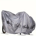 Gray bike cover with bicycle print, close-up view over the rear half of a bicycle