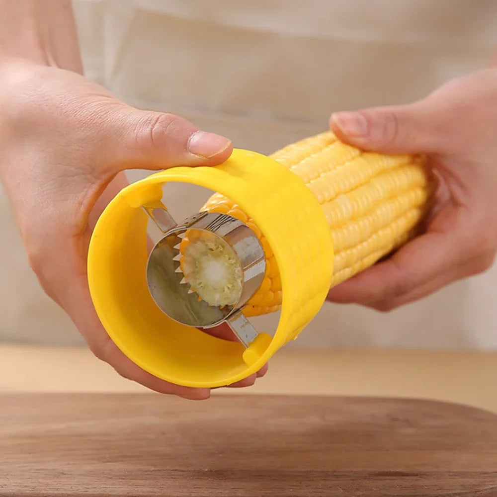 Yellow corn cob stripper peeler in hands with serrated wheel cutting corn cob.