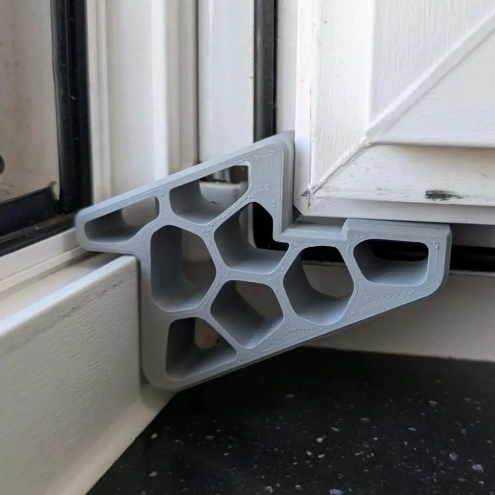 Gray door stop wedge with track lock and anti-slip ridged base for sliding doors