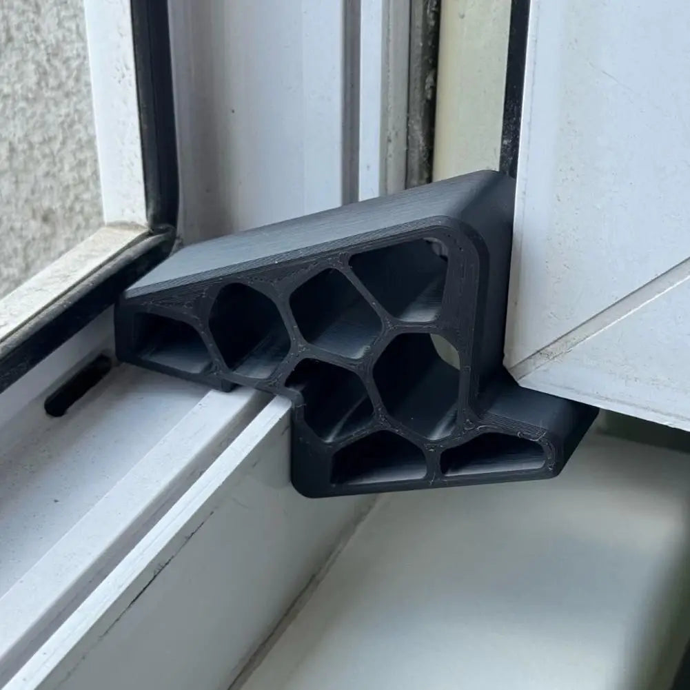 Black window and balcony door stopper wedge installed at the door frame