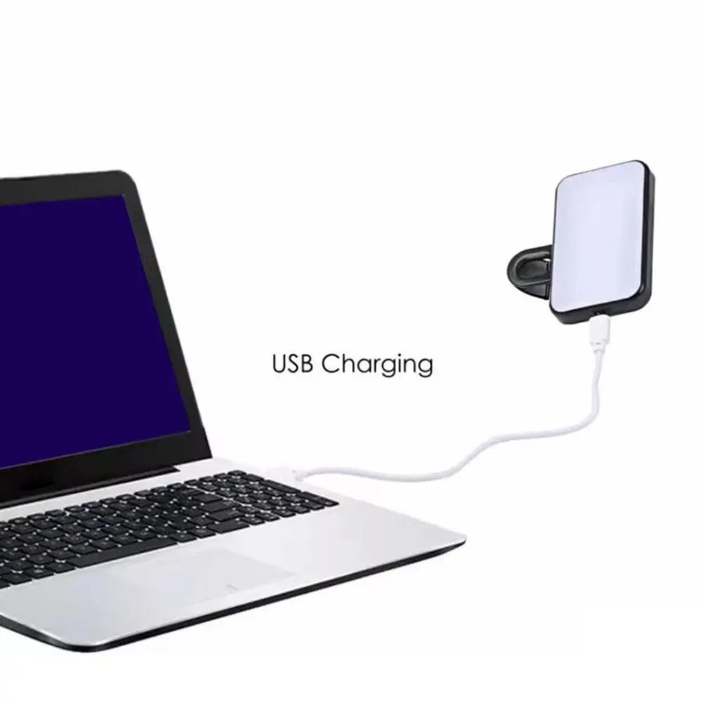 Clip-on LED selfie light attached to laptop, with visible USB charging cable