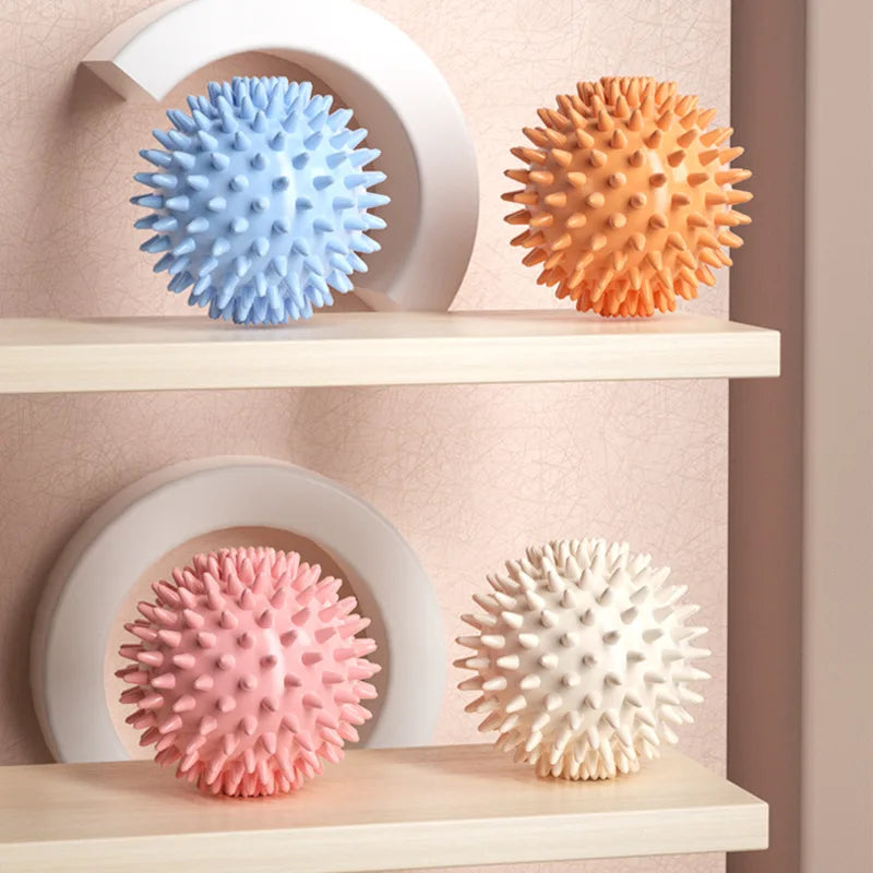 Set of spiked massage fascia balls in blue, orange, pink, and white