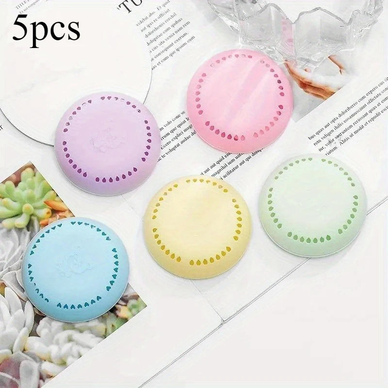 Five colorful round aromatherapy deodorizing tablets: purple, pink, yellow, blue, green