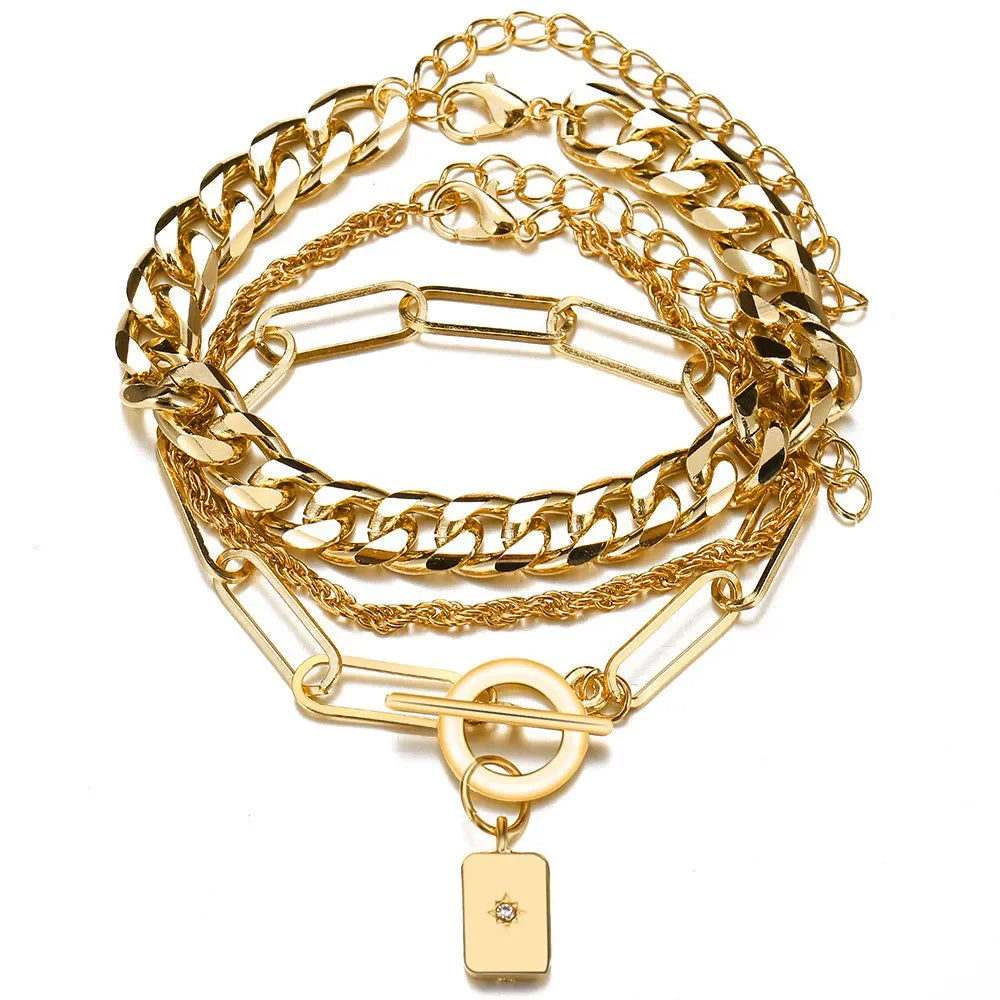Gold-tone chunky chain bracelet set with hex charm and rectangular lock pendant