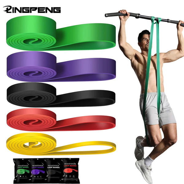 Resistance loop bands set with green, purple, black, red, and yellow bands shown on a trainer