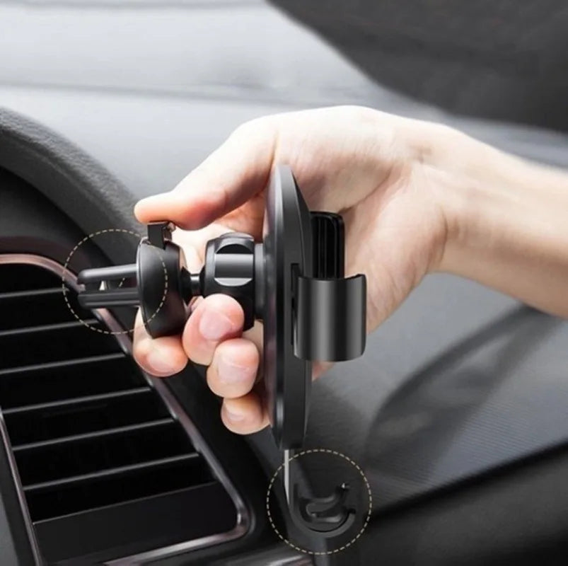 Hand installing black air-vent phone holder with spring clamp attachment on dashboard vents