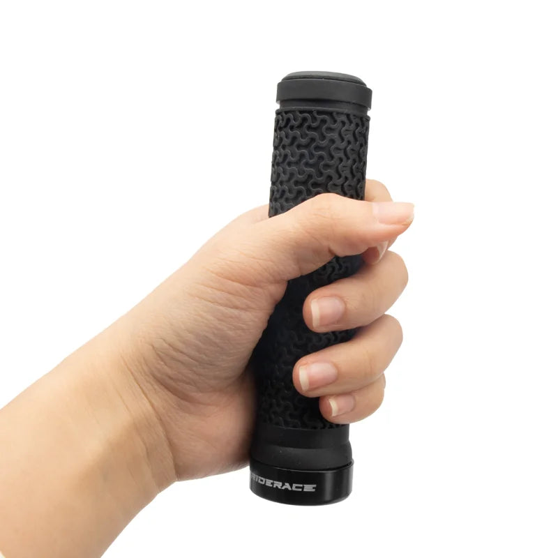 Black textured bike handlebar grip held in hand with locking end cap
