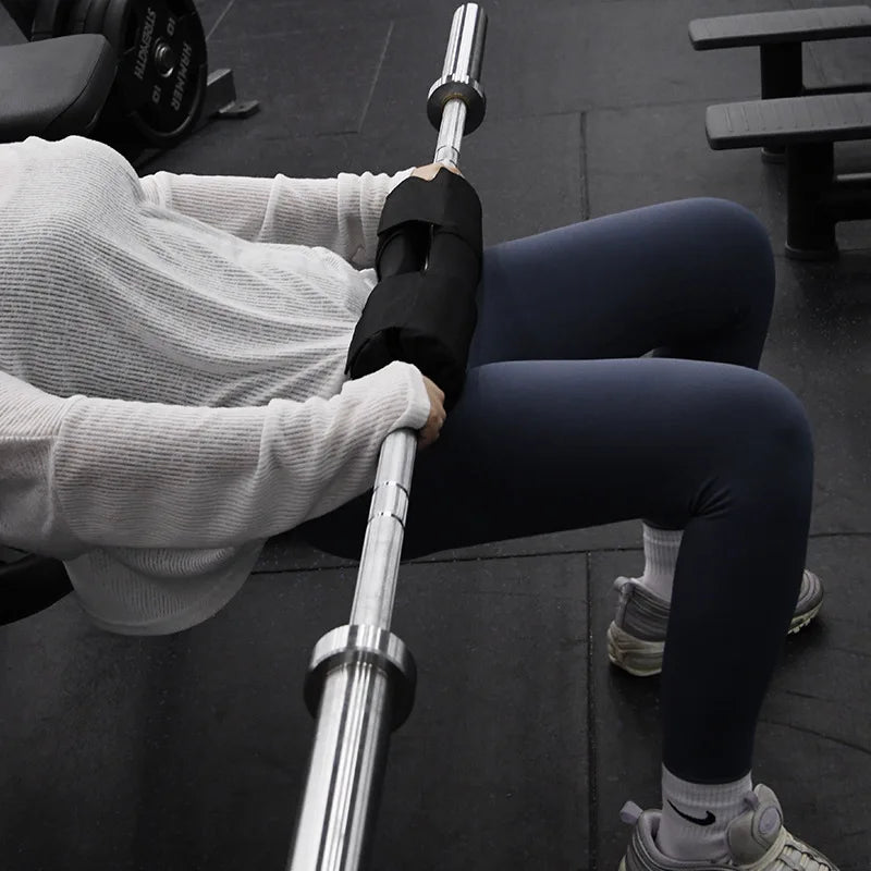 Black foam bar pad on a barbell across the shoulders for bar support