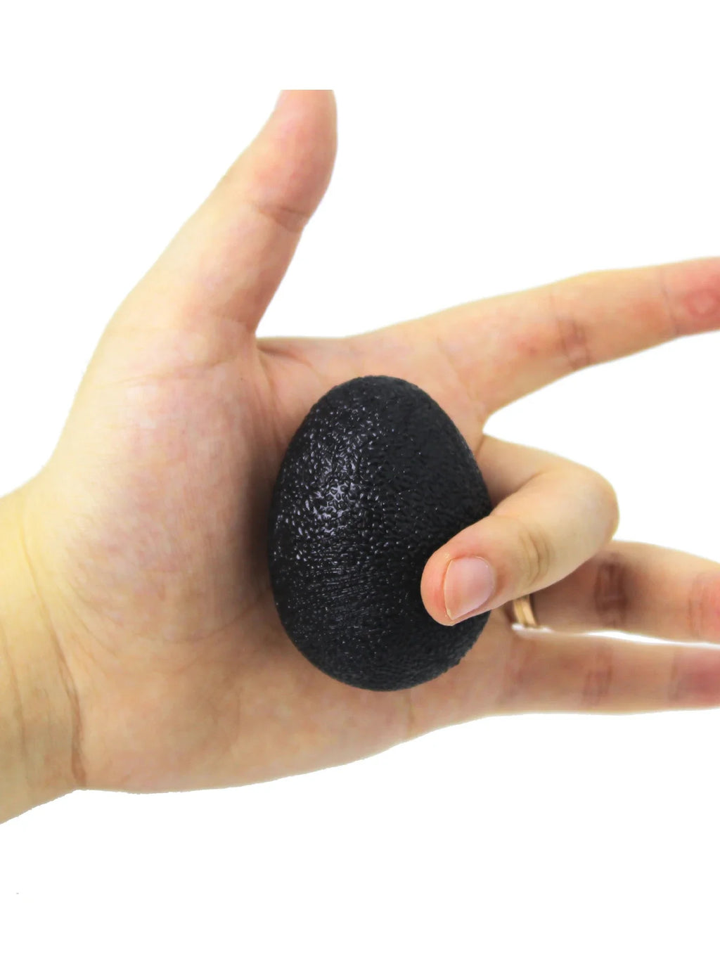 Black egg-shaped grip strength ball held in open hand for hand grip training