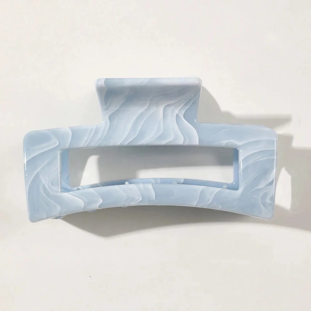 Light blue rectangular claw clip with swirled translucent pattern