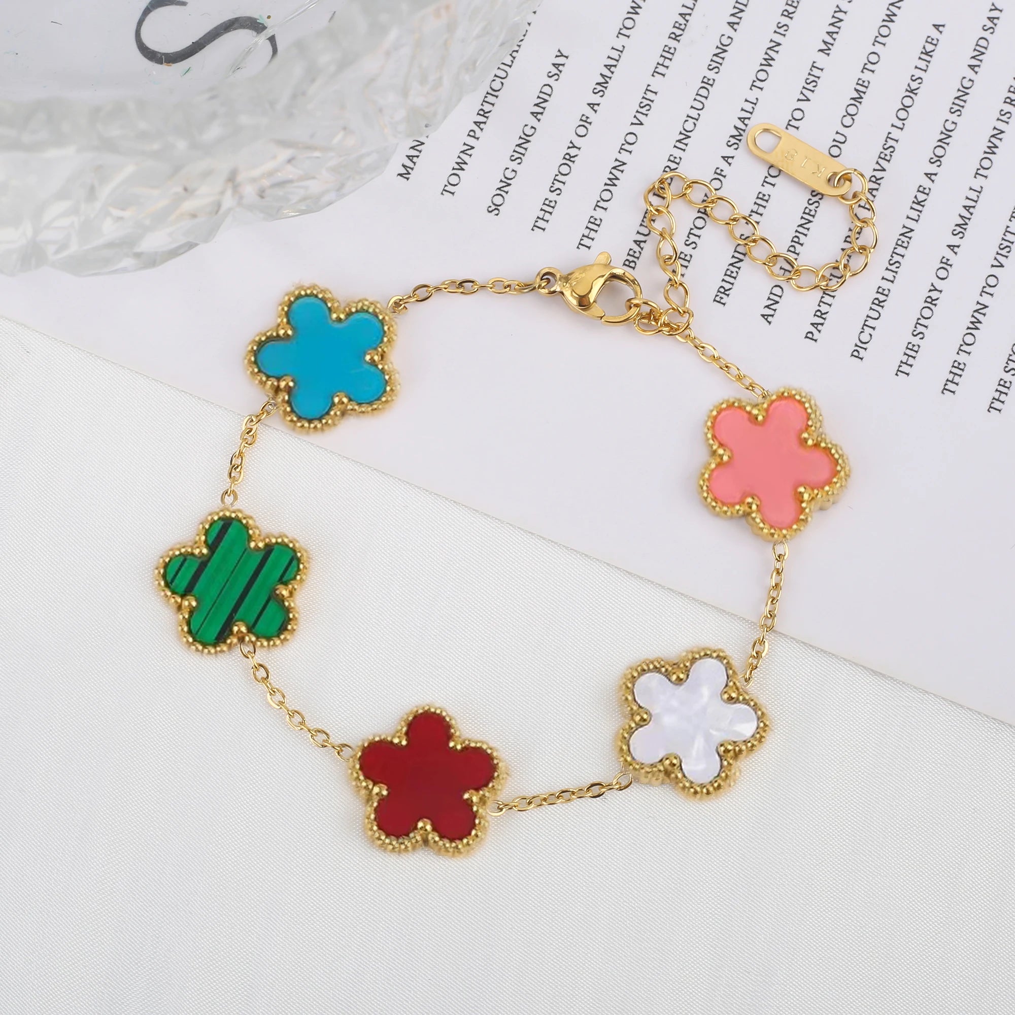 Adjustable clover charm bracelet with mixed-color enamel four-leaf pendants on gold chain