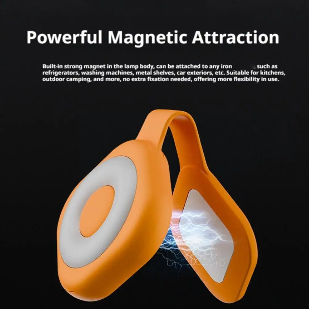 Orange magnetic LED light with white ring glow and visible attraction lines
