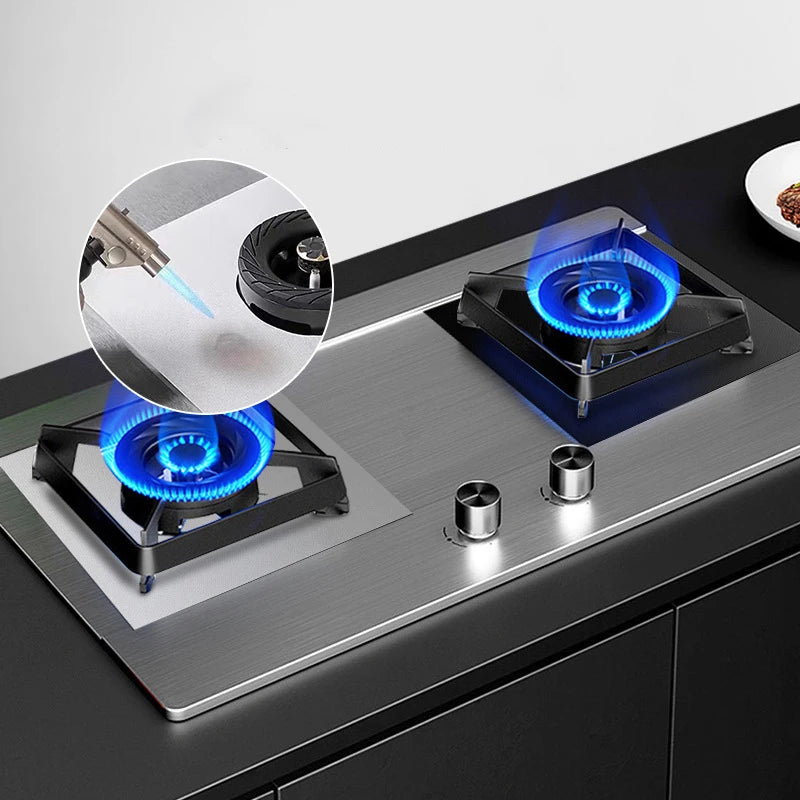 Black stove protector pads on gas cooktop surface with visible blue burner flames