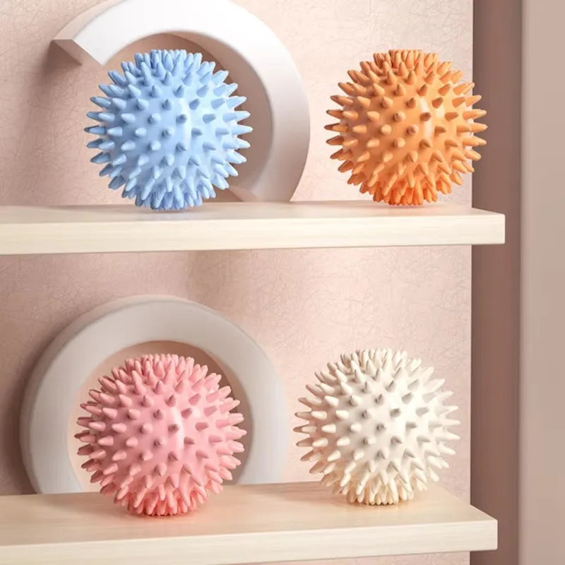 Four-pack fascia massage balls on shelves: blue, orange, pink, and white
