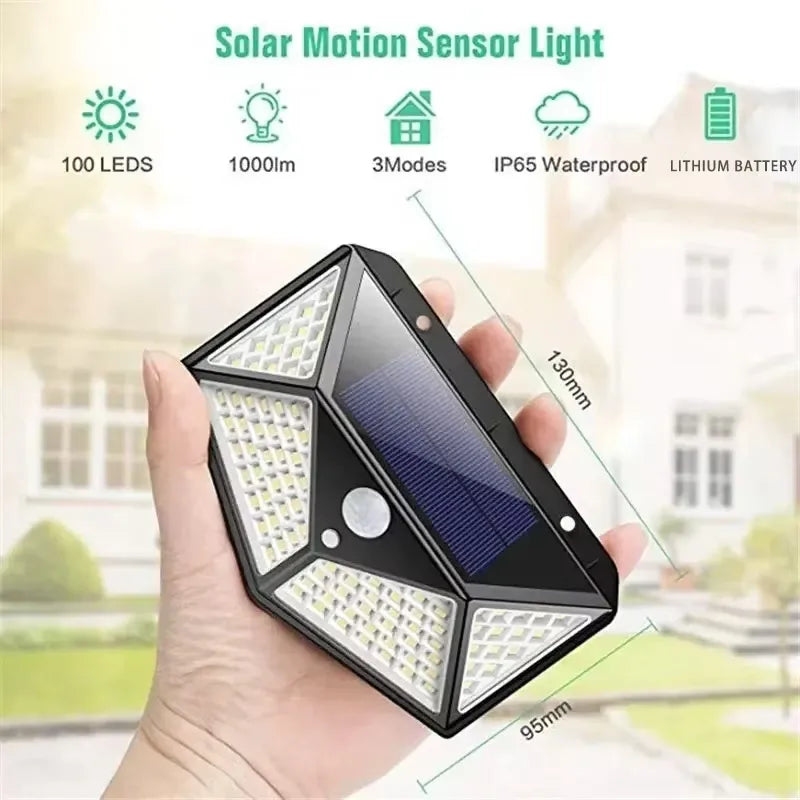 Solar powered motion sensor light held in hand; black frame with three LED sections