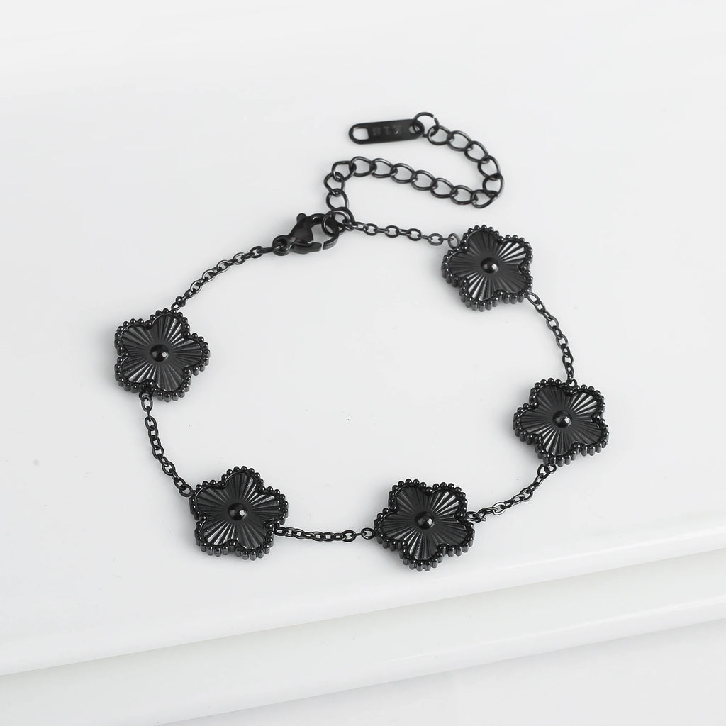 Adjustable black flower charm bracelet with five dark clover-like pendant beads