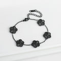 Adjustable black flower charm bracelet with five dark clover-like pendant beads