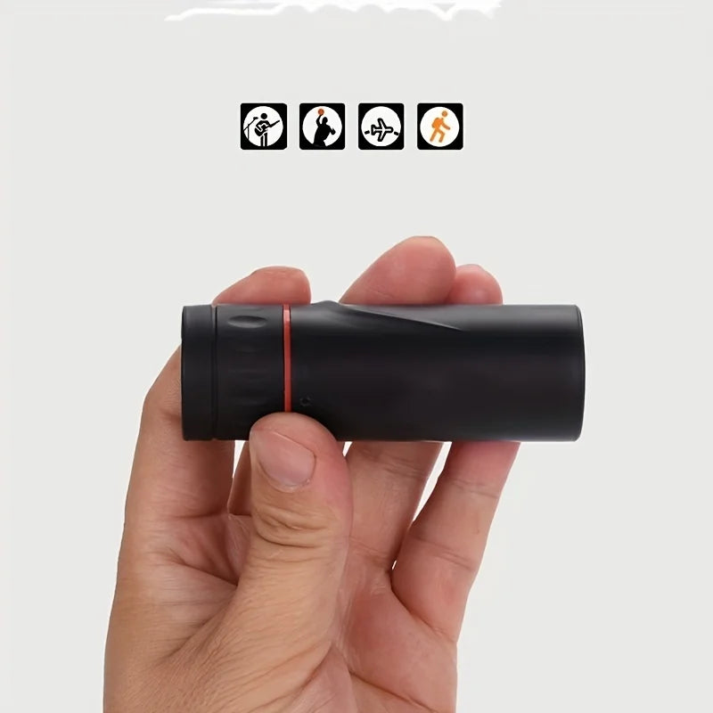 Black compact monocular telescope with red ring, side profile held by hand