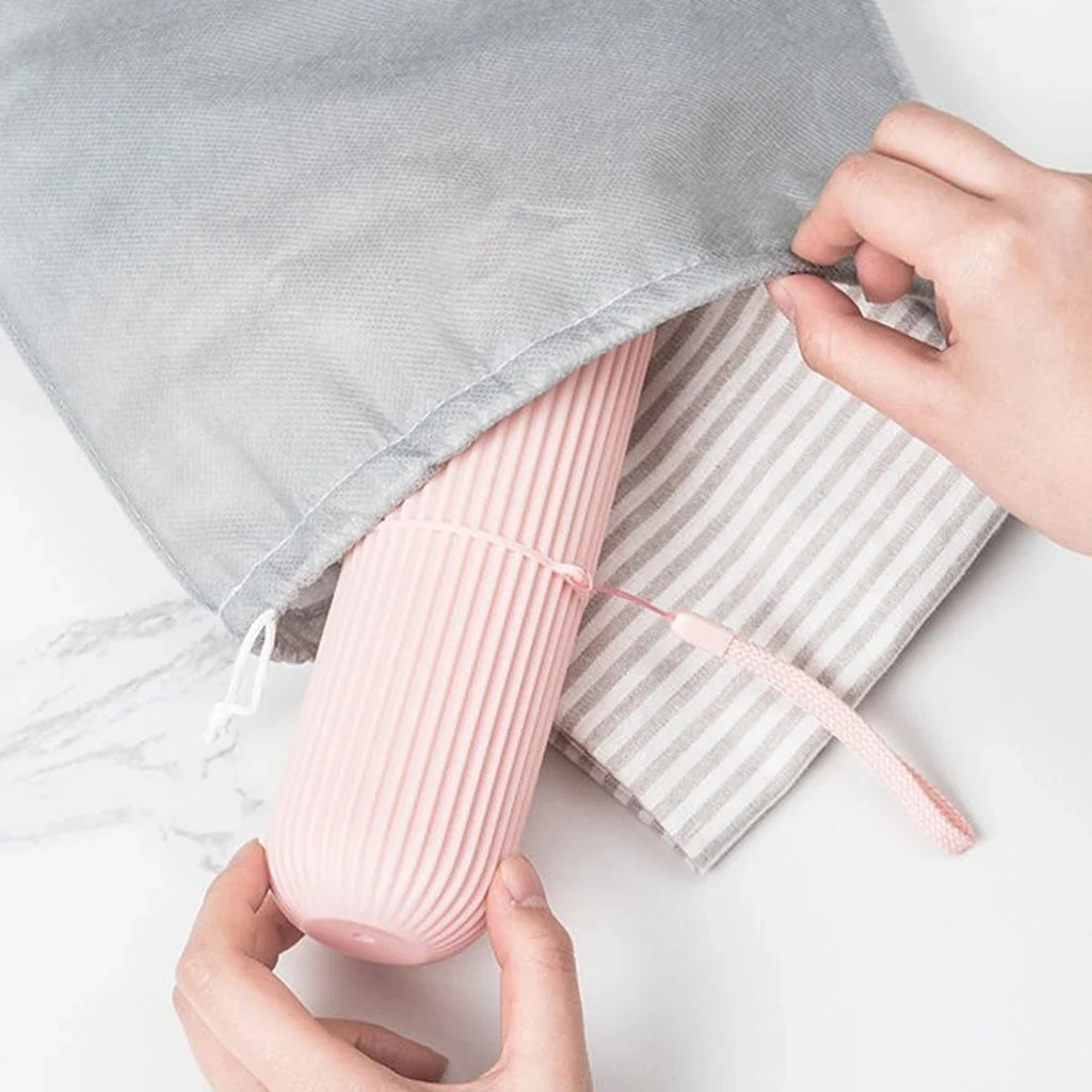 Pink ribbed travel toothbrush holder cup with lid and pouch