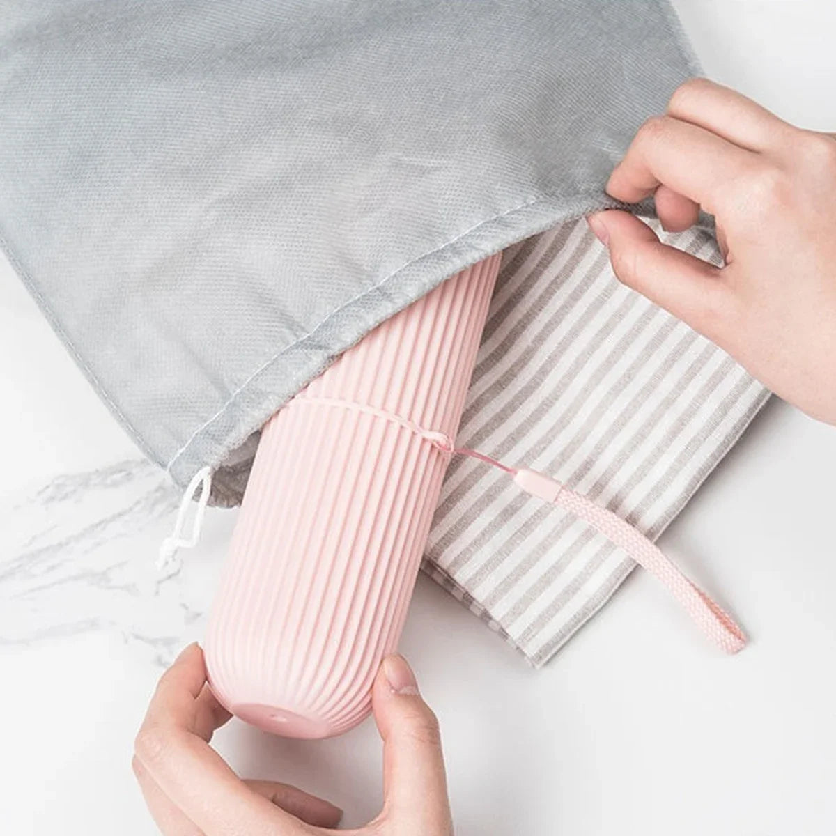 Pink ribbed travel toothbrush holder cup with lid and pouch