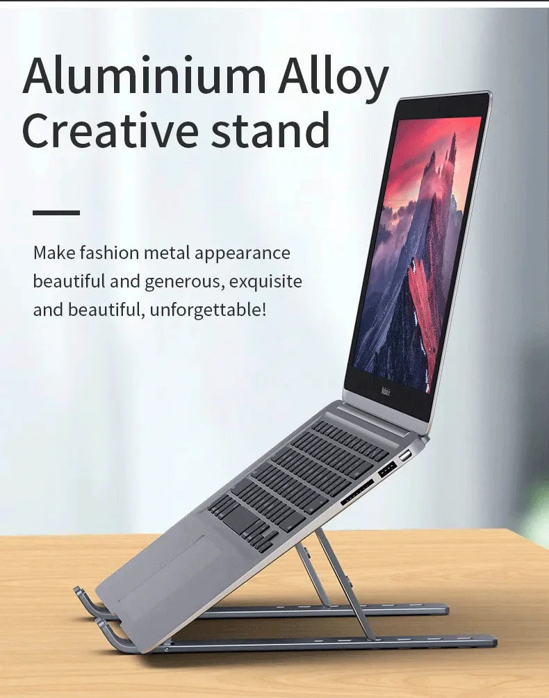 Aluminum alloy laptop stand in light gray with adjustable tilt and vented underside.