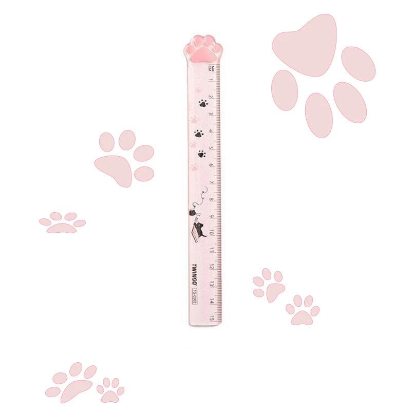 Pink plastic straight ruler with cat paw-shaped top and paw-print scale