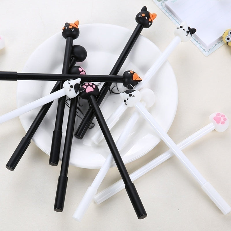 Kawaii cat gel pen set (10-pack) in a bowl: multiple black pens with cat claw caps